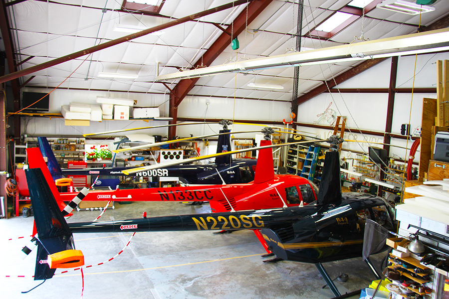 Robinson R44 helicopters parked in Midwest Aeronautical maintenance hangar