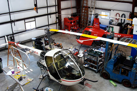 two R22 helicopters during routine maintenance