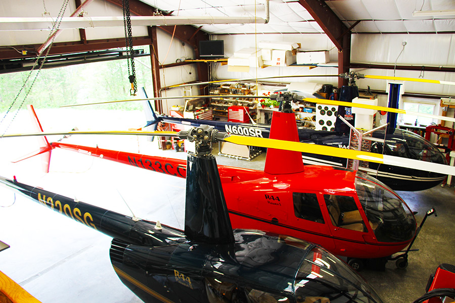 R44 helicopters in hangar for maintenance